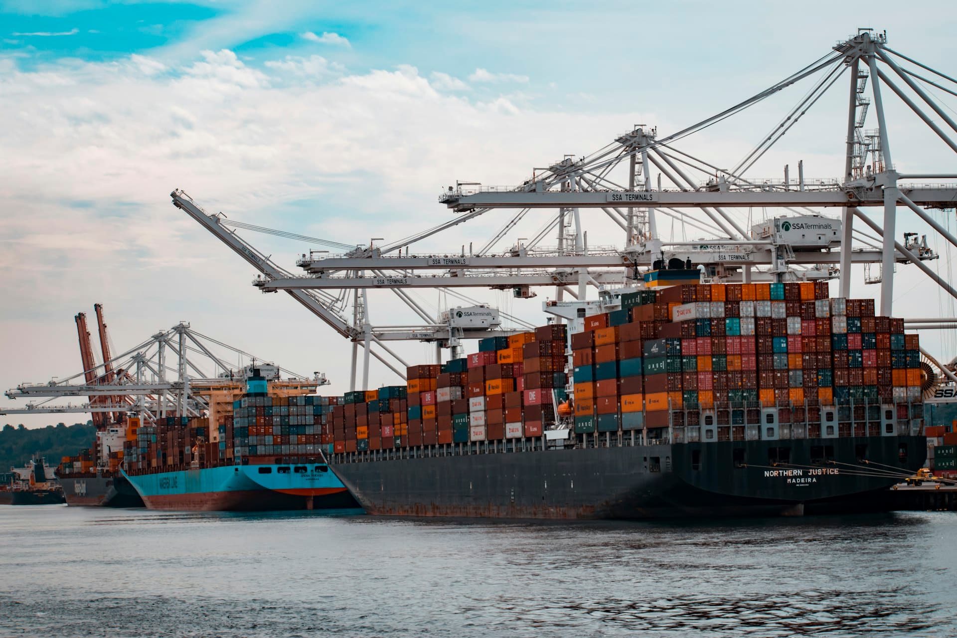 Container ships at port with cranes representing global shipping reach