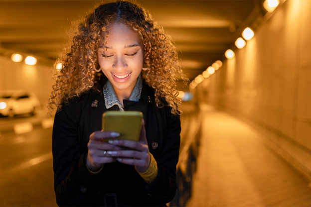 an image a woman using her phone in a tunnel